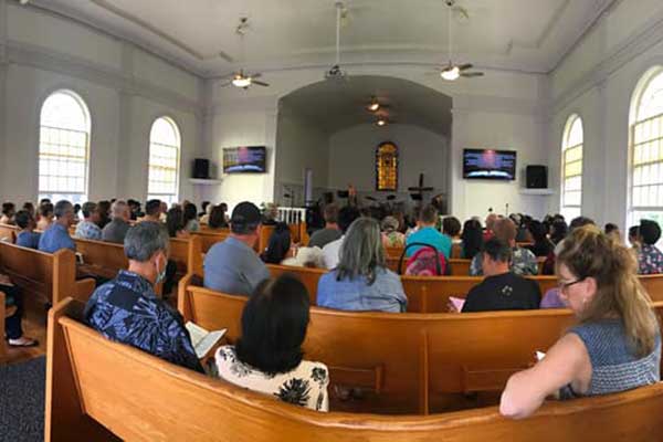 Congregation gathered for worship service inside The Church at Koloa sanctuary on Kauai.