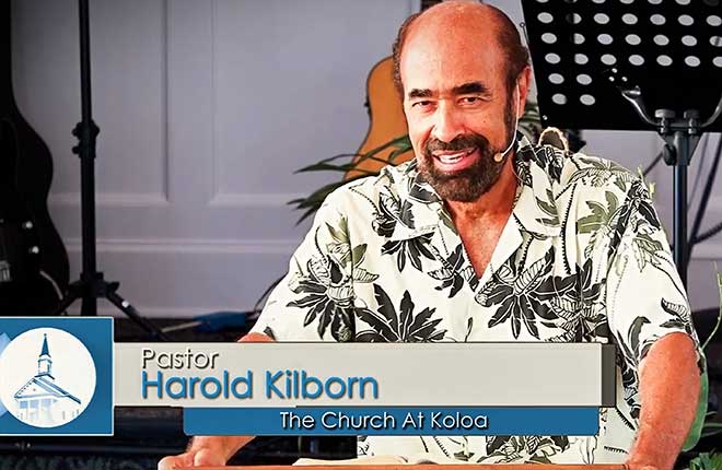 Pastor Harold Kilborn preaching behind the pulpit at The Church at Koloa.